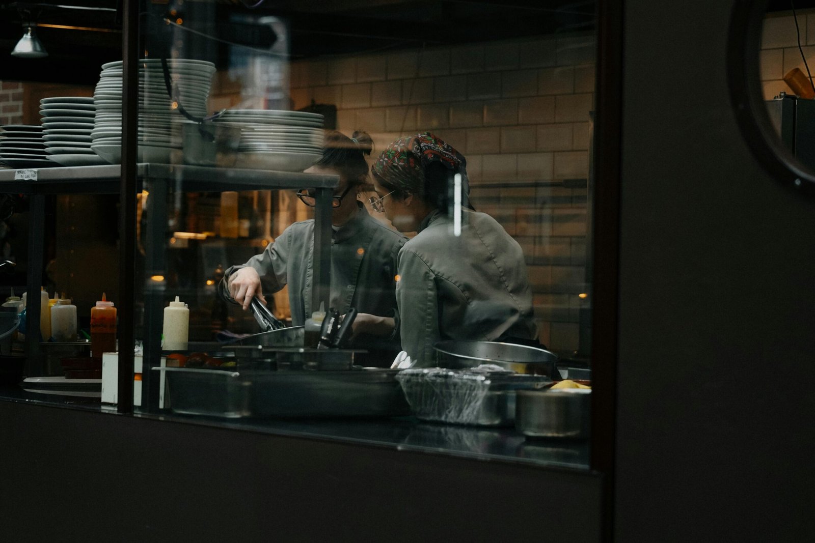 Candid shot of chefs cooking in a restaurant kitchen in Amsterdam.